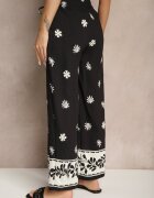 sophyline paris Pantaloni negri din vâscoză cu croială largă cu elastic în talie cu imprimeu floral Nimilassa