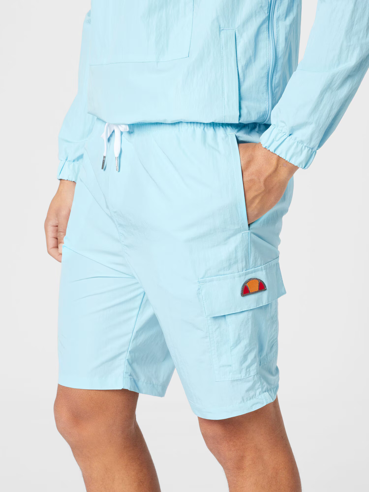 ELLESSE Pantaloni sport 'Chaps' albastru deschis / portocaliu / roșu - Pled.ro