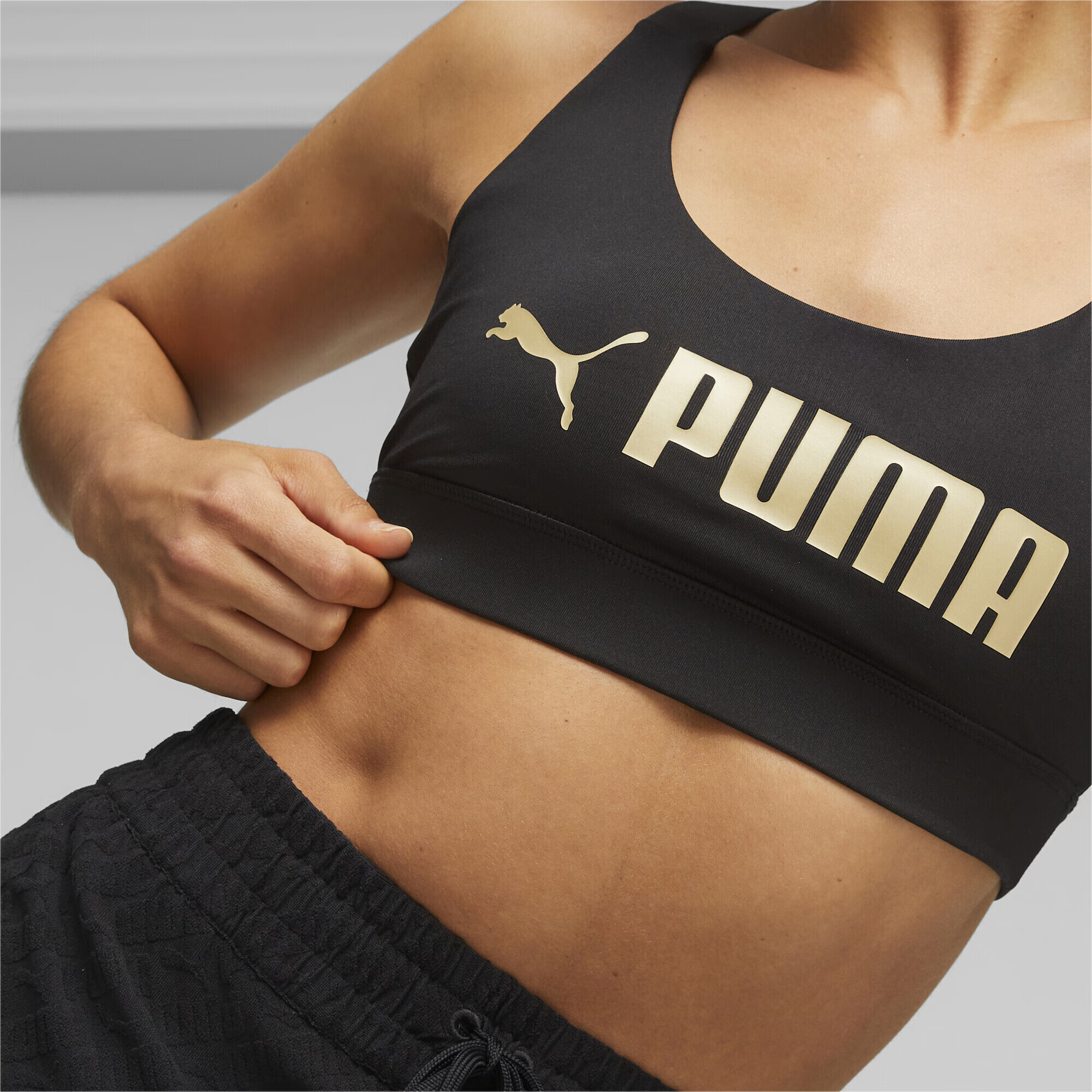 PUMA Sutien sport auriu / negru - Pled.ro