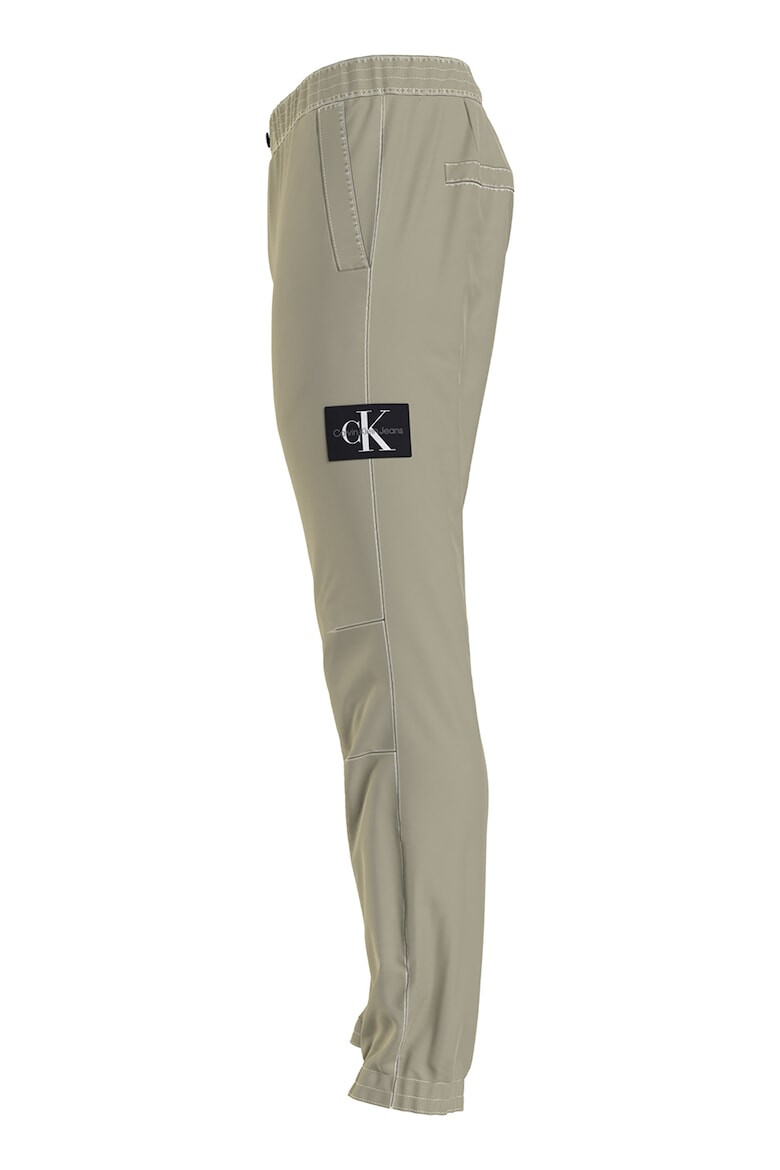 CALVIN KLEIN JEANS Pantaloni conici cu aplicatie logo - Pled.ro