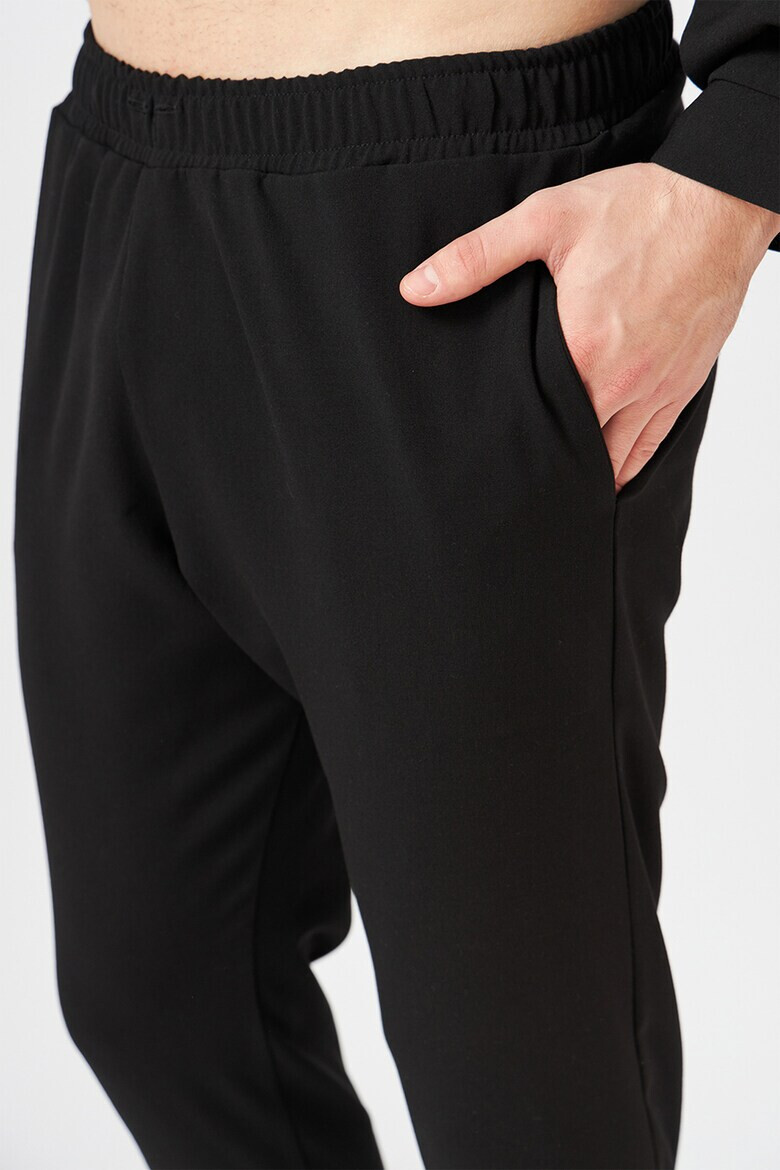 Jaisse Pantaloni sport conici cu buzunare oblice - Pled.ro