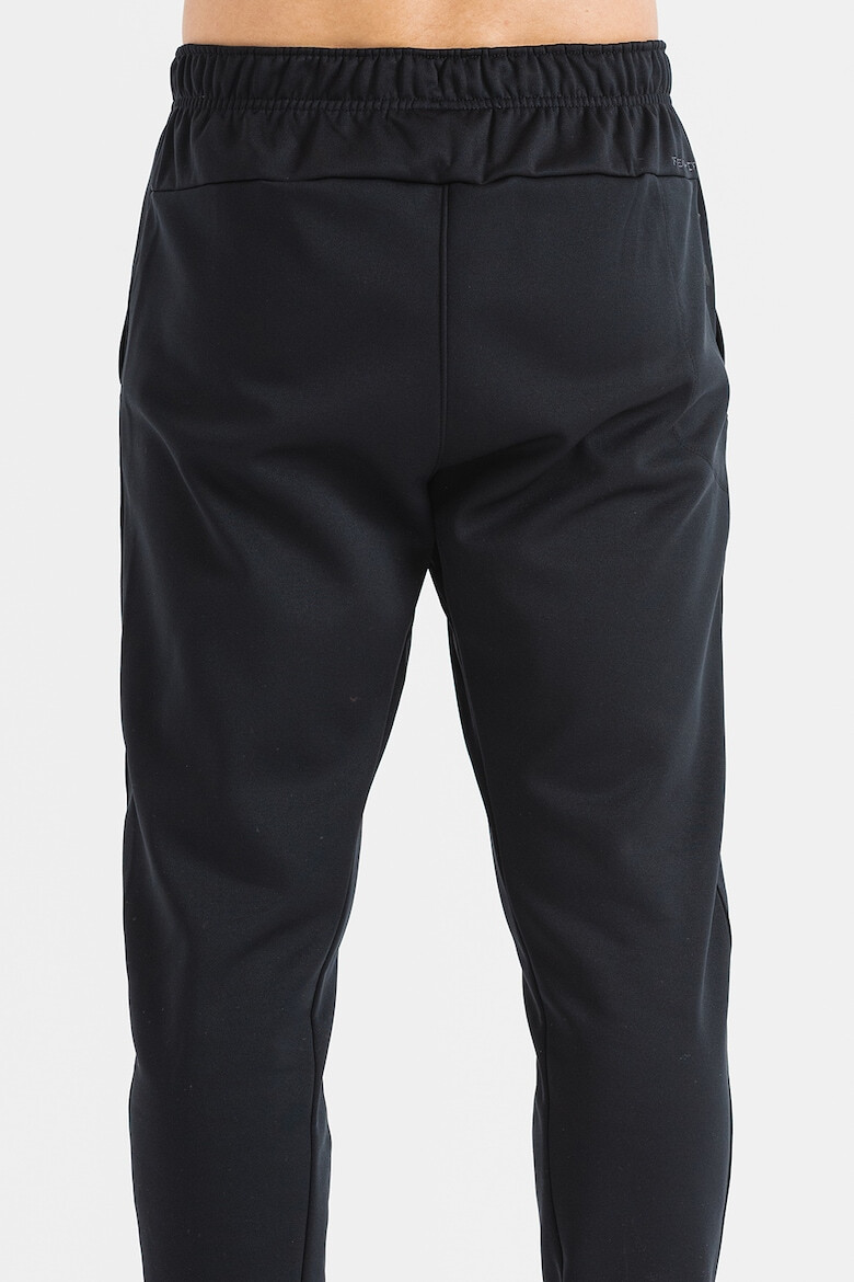 Nike Pantaloni conici cu logo pentru fitness - Pled.ro