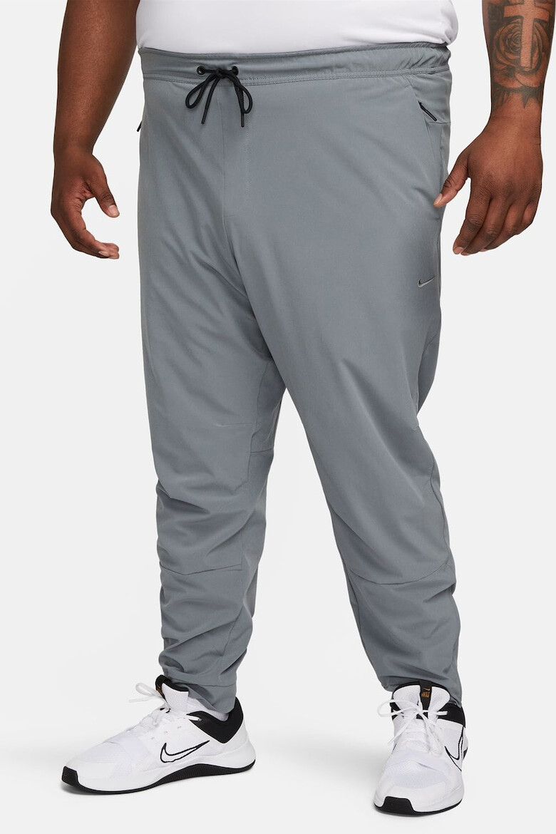 Nike Pantaloni conici cu tehnologie Dri-FIT si slituri cu fermoar Unlimited - Pled.ro