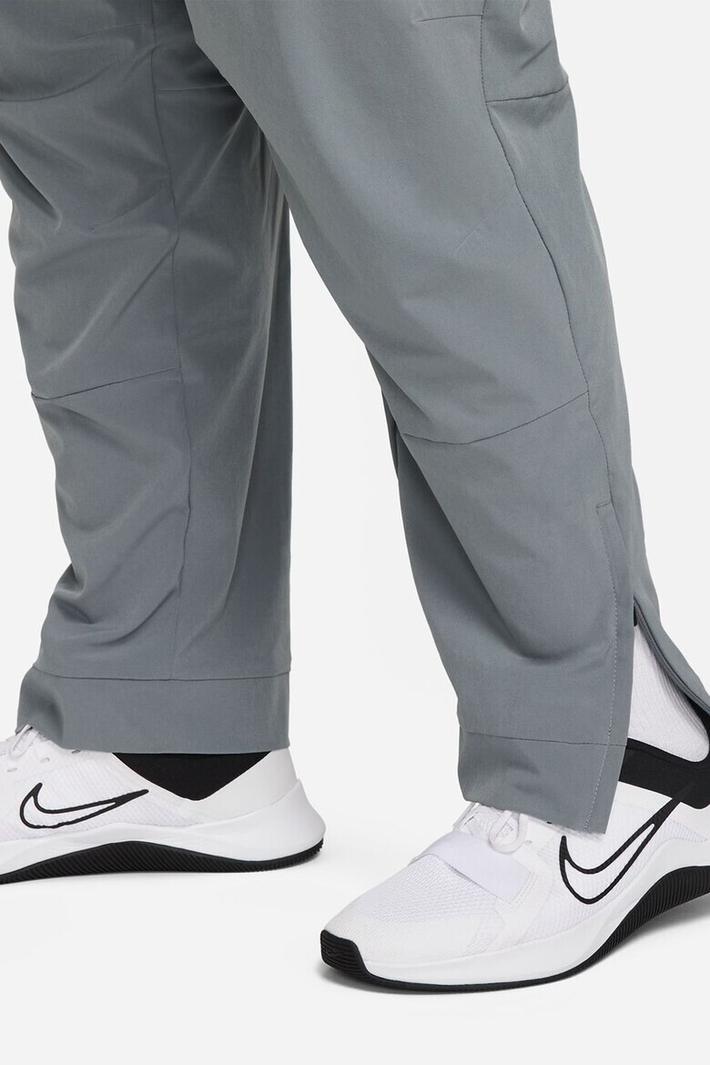 Nike Pantaloni conici cu tehnologie Dri-FIT si slituri cu fermoar Unlimited - Pled.ro