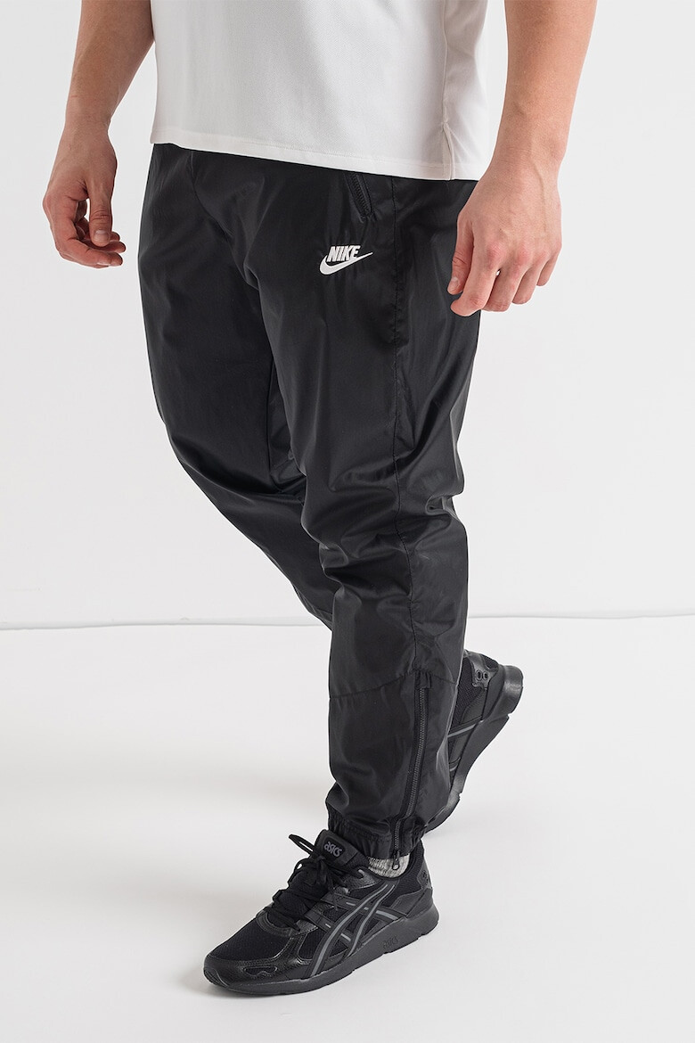 Nike Pantaloni cu slituri cu fermoar la glezna Windrunner - Pled.ro