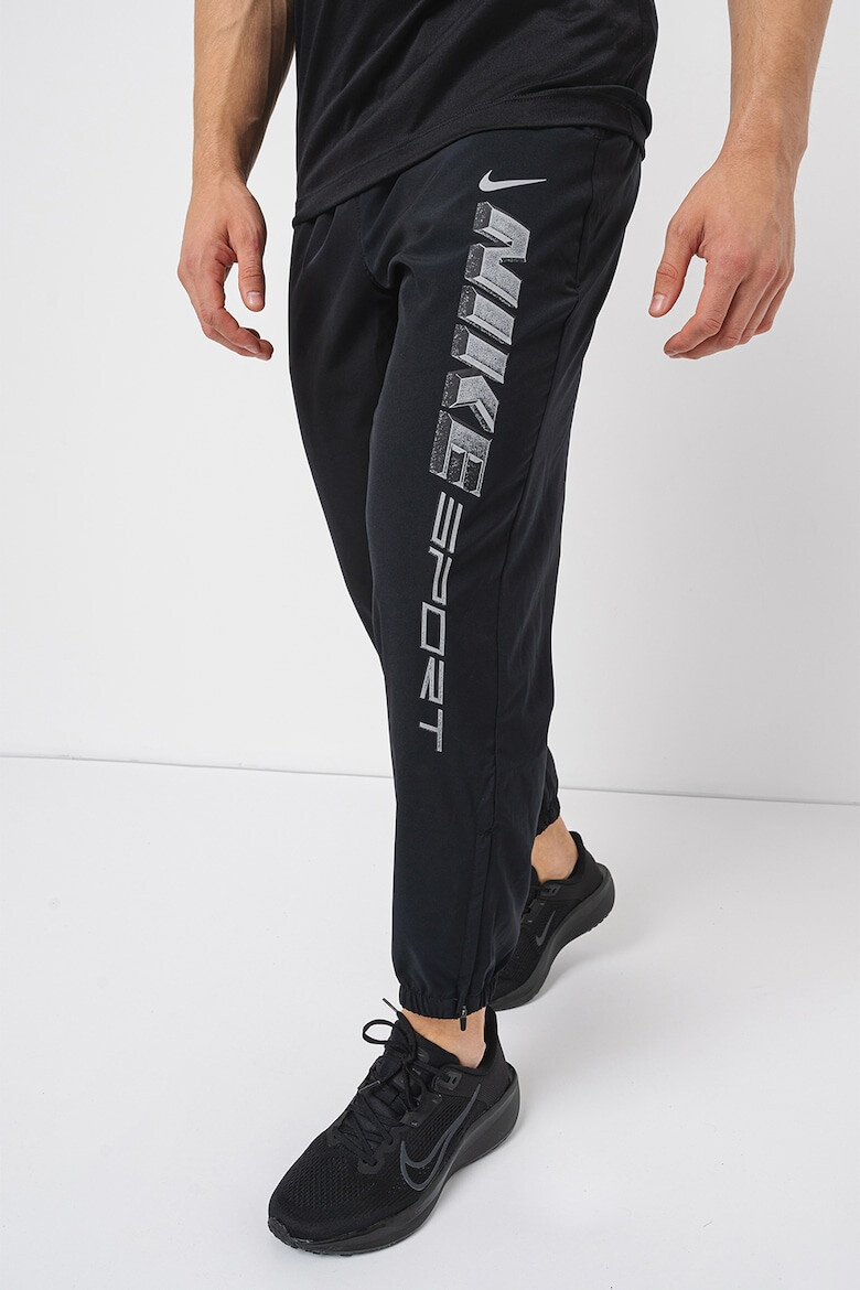 Nike Pantaloni cu tehnologie Dri-Fit imprimeu logo si buzunare oblice pentru fitness - Pled.ro