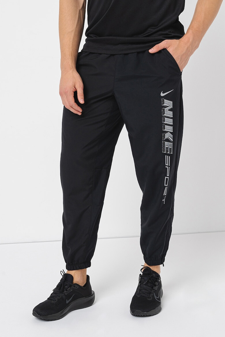 Nike Pantaloni cu tehnologie Dri-Fit imprimeu logo si buzunare oblice pentru fitness - Pled.ro