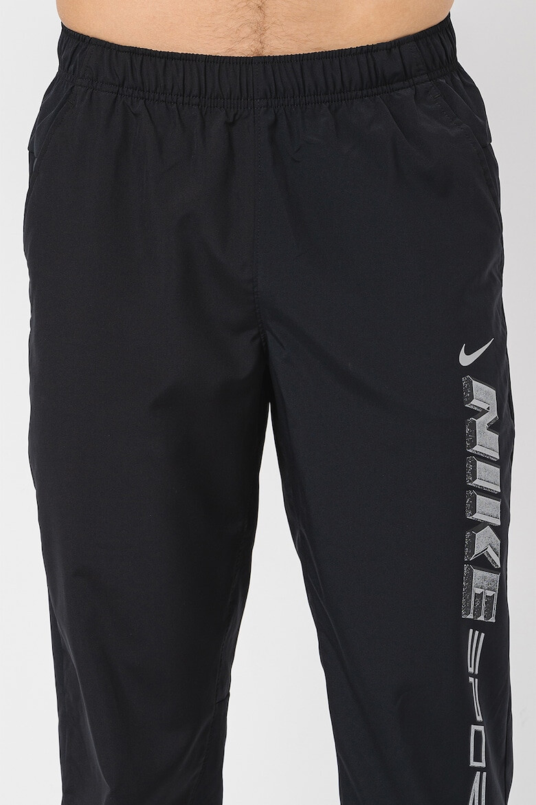 Nike Pantaloni cu tehnologie Dri-Fit imprimeu logo si buzunare oblice pentru fitness - Pled.ro