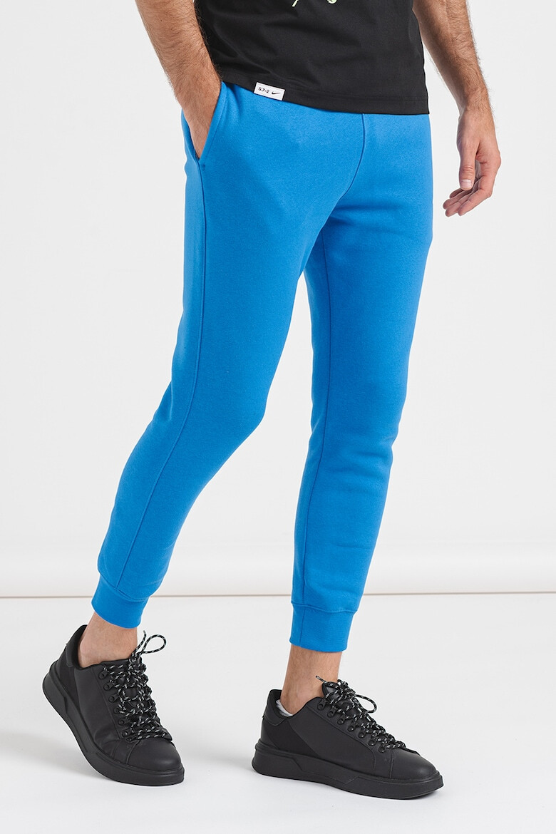 Nike Pantaloni de trening cu buzunare laterale - Pled.ro