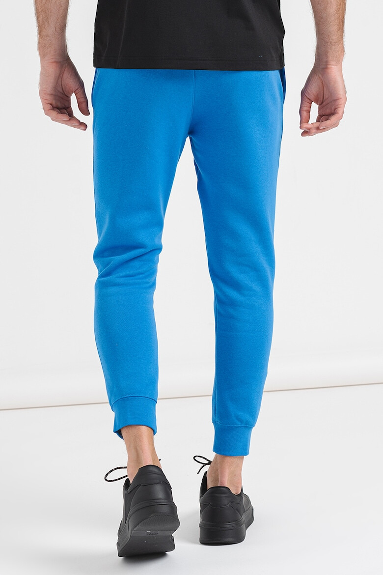 Nike Pantaloni de trening cu buzunare laterale - Pled.ro