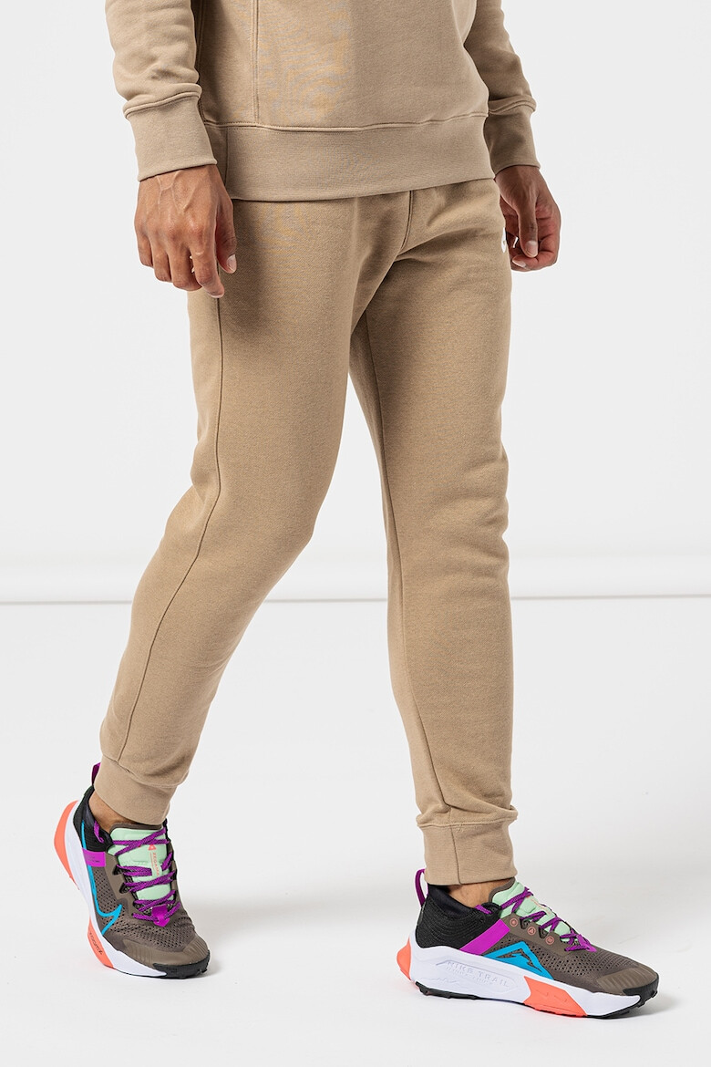 Nike Pantaloni de trening cu buzunare laterale - Pled.ro