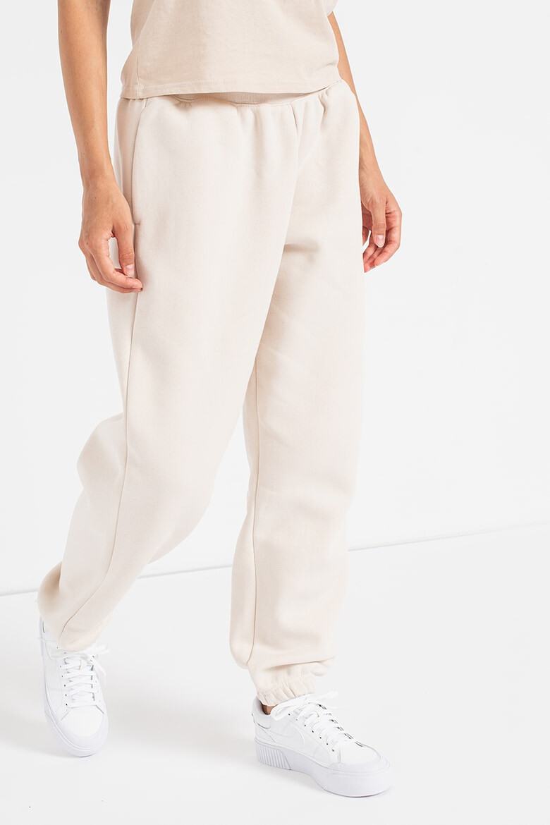 Nike Pantaloni de trening relaxed fit cu logo Phoenix - Pled.ro