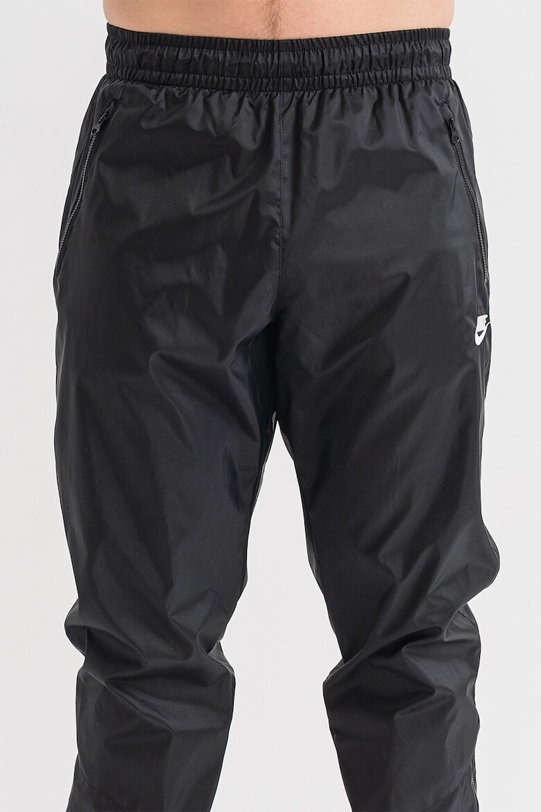 Nike Pantaloni cu slituri cu fermoar la glezna Windrunner - Pled.ro