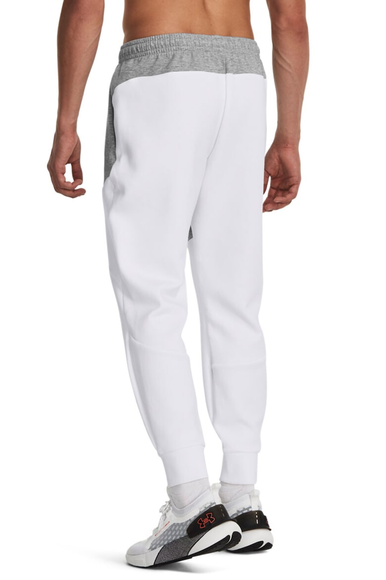 Under Armour Pantaloni conici cu uscare rapida pentru fitness Unstoppable - Pled.ro