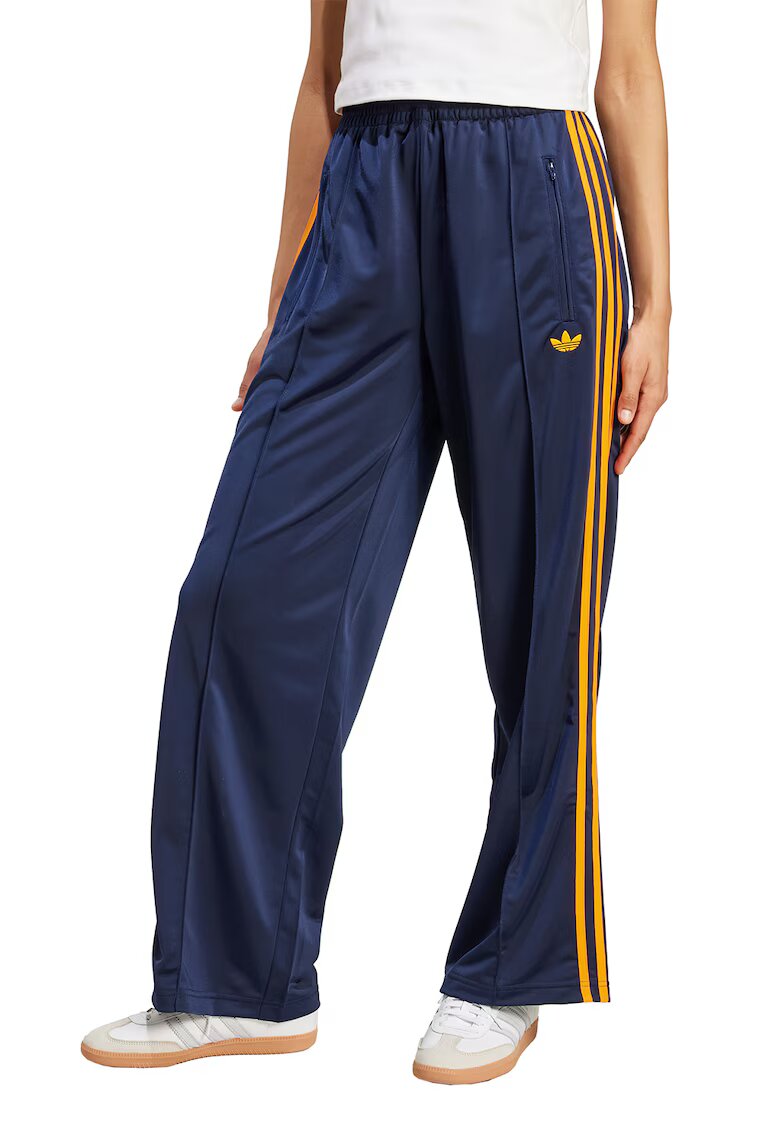 adidas Originals Pantaloni de trening cu croiala lejera si buzunare cu fermoar Firebird - Albastru inchis/Galben pai