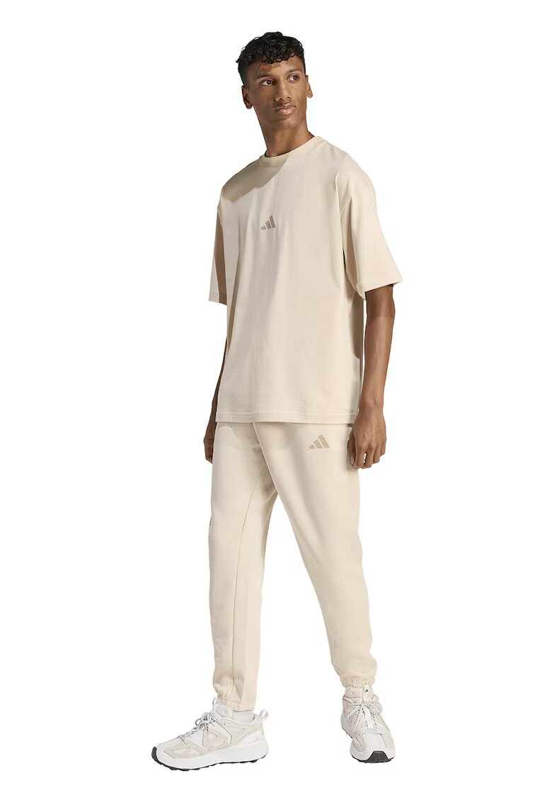ADIDAS SPORTSWEAR Pantaloni de trening conici cu buzunare laterale - Crem