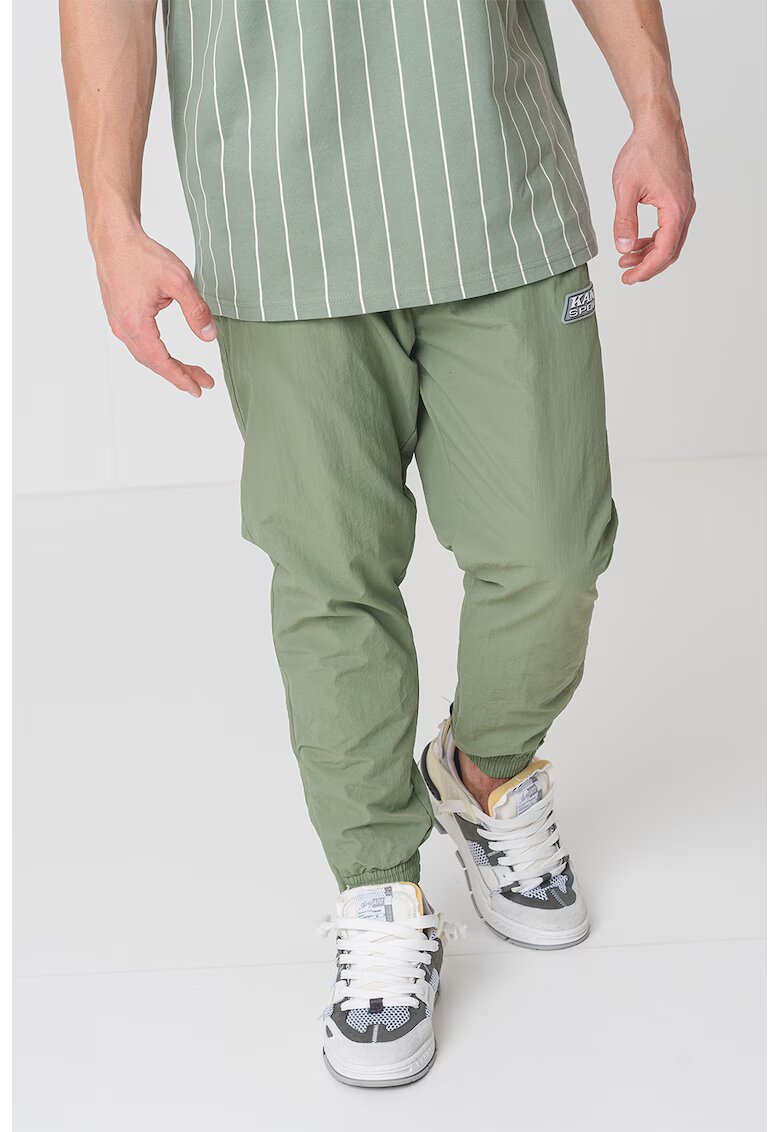 Karl Kani Pantaloni de trening relaxed fit Sport Patch Essential - Verde aquamarin/Alb murdar