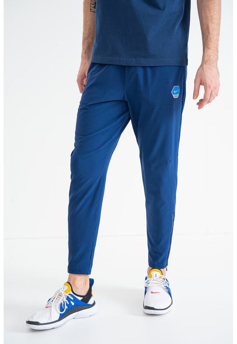 Nike Pantaloni conici de trening cu logo - Albastru inchis