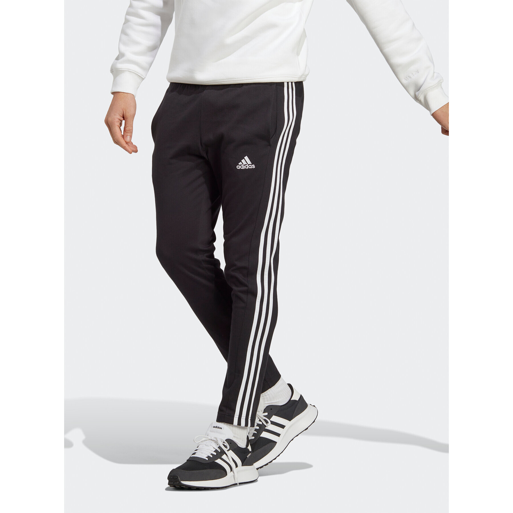 adidas Pantaloni trening Essentials Single Jersey Tapered Open Hem 3-Stripes Joggers IC0044 Negru Regular Fit - Pled.ro