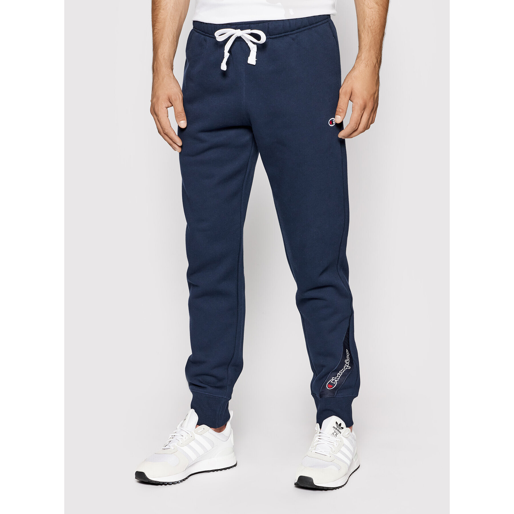 Champion Pantaloni trening Blend Small Script Logo 216552 Bleumarin Regular Fit - Pled.ro