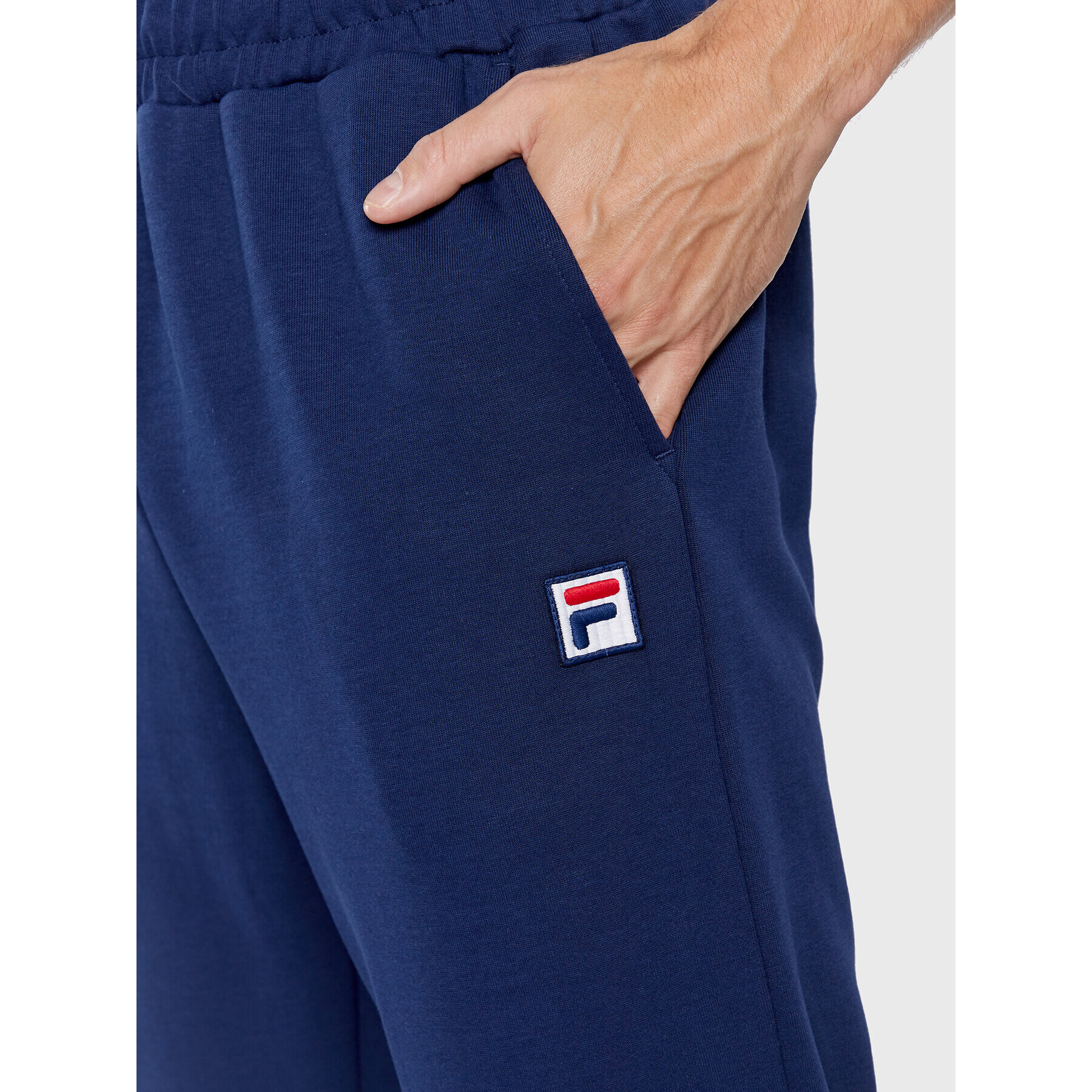 Fila Pantaloni trening Zigong FAM0169 Bleumarin Regular Fit - Pled.ro