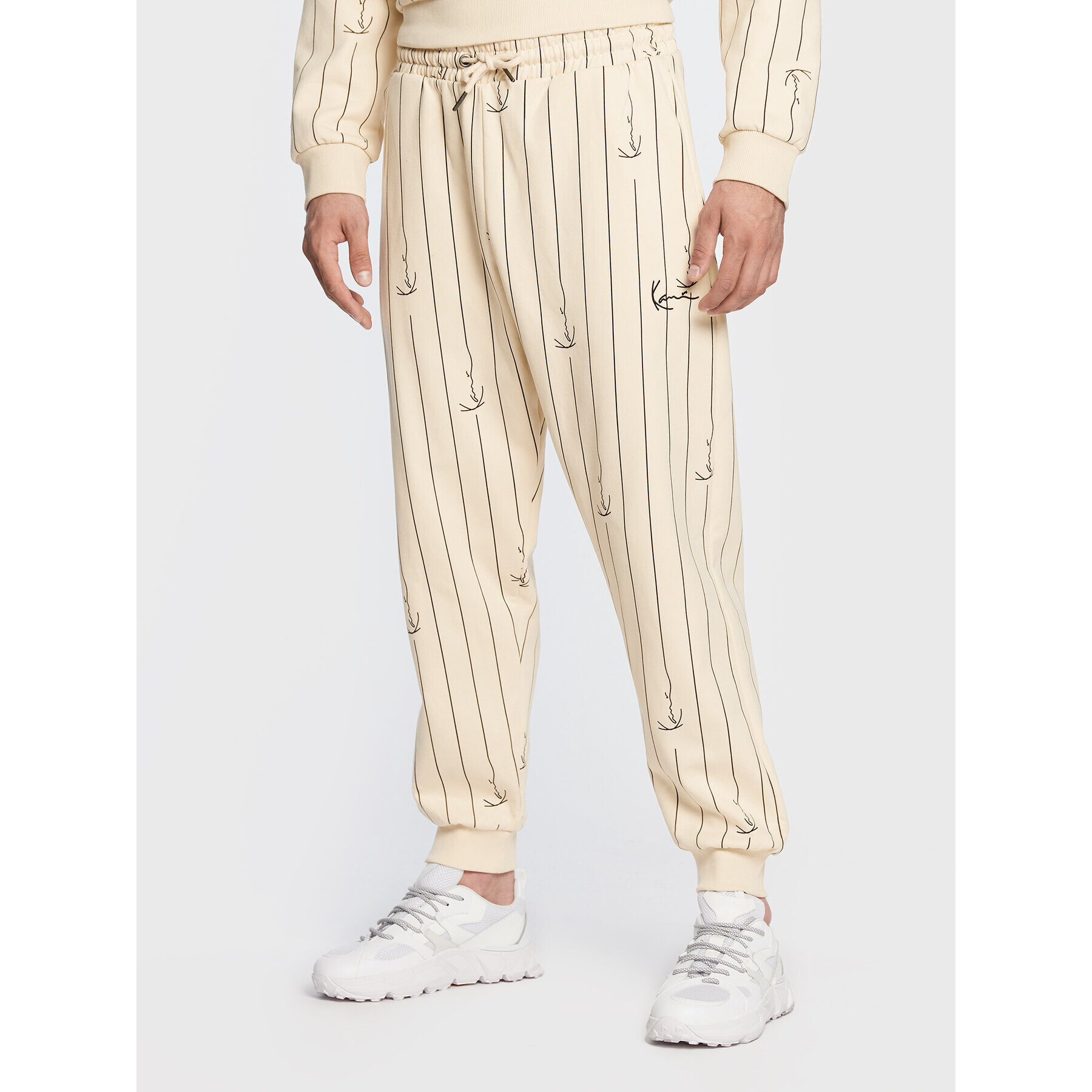 Karl Kani Pantaloni trening Small Signature Logo Pinstripe 6004670 Bej Relaxed Fit - Pled.ro