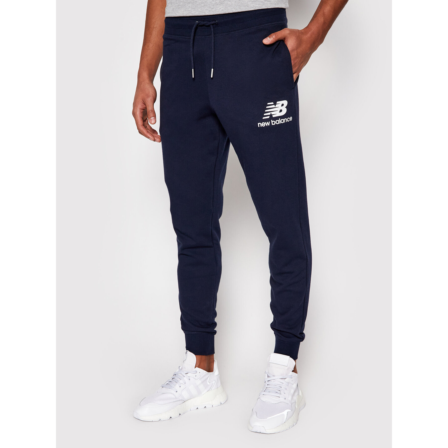 New Balance Pantaloni trening Essentials Stacked Logo MP03558 Bleumarin Athletic Fit - Pled.ro