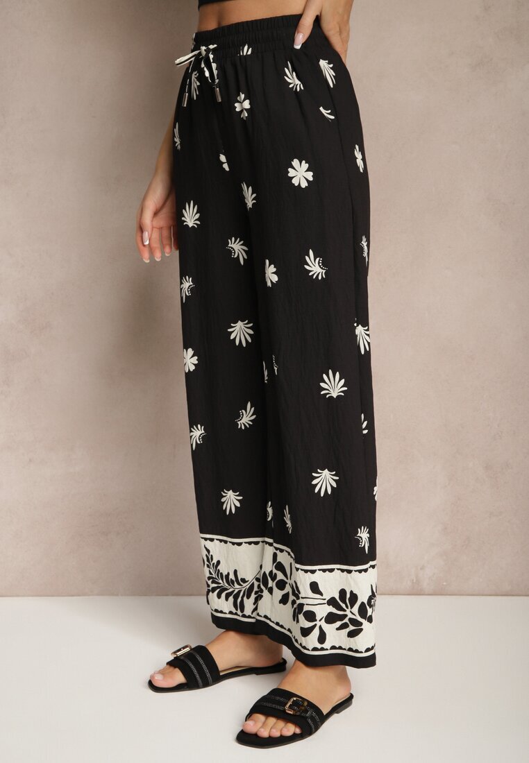 sophyline paris Pantaloni negri din vâscoză cu croială largă cu elastic în talie cu imprimeu floral Nimilassa